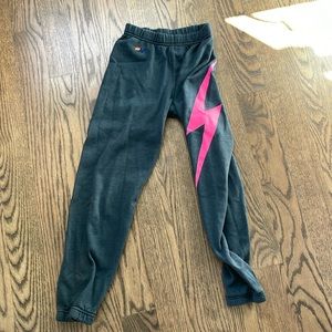 Aviator nation in a size 12 for kids and black with a hot pink lighting bolt.
